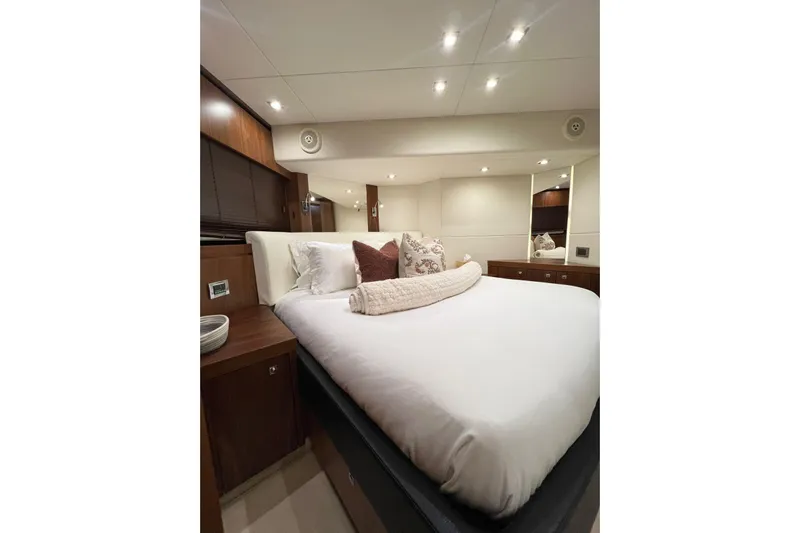 Ohana Yacht Photos Pics Luxurious bedroom interior of 2012 Sunseeker Manhattan 73 yacht with elegant bedding.