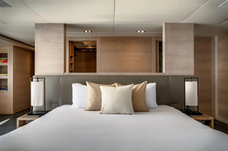 Fast & Furious Yacht Photos Pics Luxurious bedroom interior on AB 145 yacht, 2016 model, featuring modern design and neutral tones.