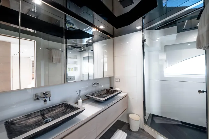 Fast & Furious Yacht Photos Pics Luxurious modern bathroom with dual sinks, glass shower, and sleek cabinetry on AB 145 yacht, 2016.