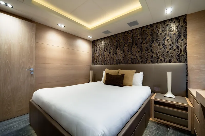 Fast & Furious Yacht Photos Pics Luxurious bedroom with modern decor, featuring elegant lighting and stylish wallpaper in AB 145 yacht.