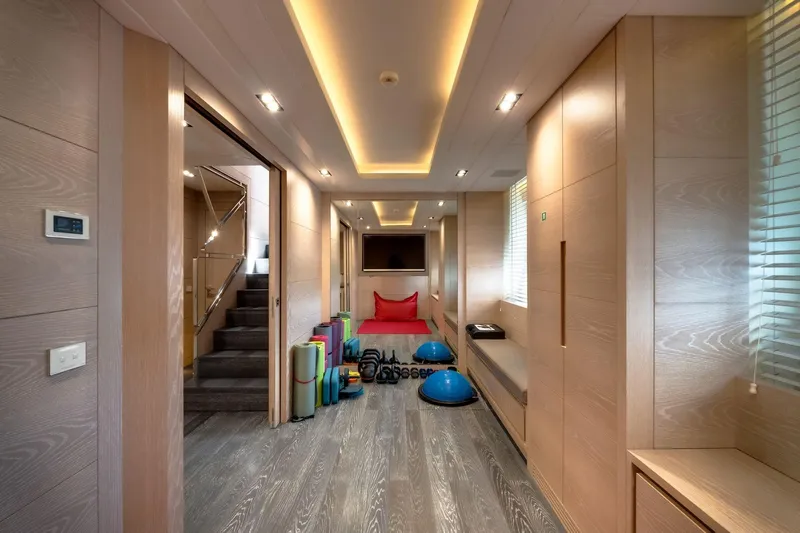 Fast & Furious Yacht Photos Pics Luxurious yacht interior with gym equipment, modern lighting, and wooden finishes, AB 145, 2016 model.