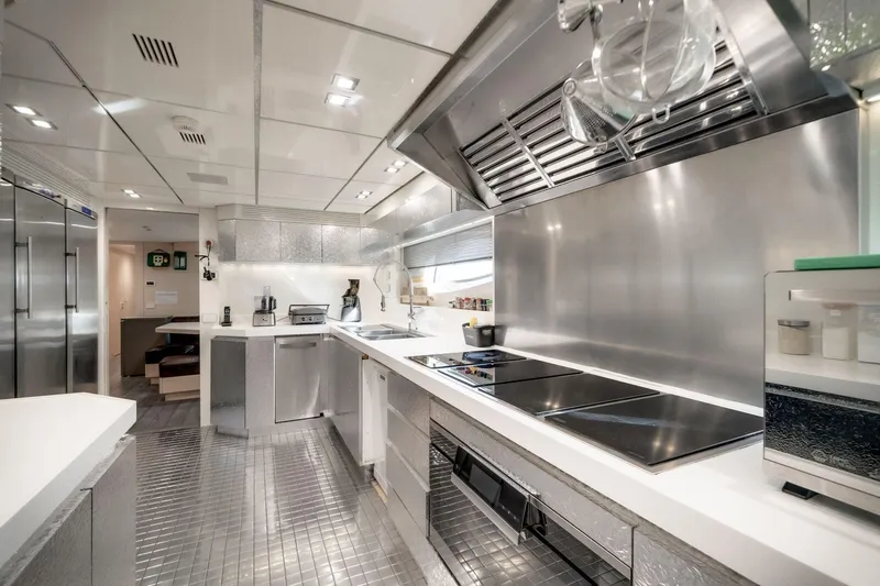 Fast & Furious Yacht Photos Pics Luxurious modern kitchen in AB 145 yacht, 2016 model, featuring sleek stainless steel appliances.