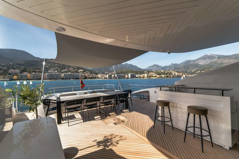 Fast & Furious Yacht Photos Pics Luxurious AB 145 yacht deck with bar, dining area, and scenic coastal view, 2016 model.