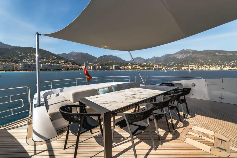 Fast & Furious Yacht Photos Pics Luxury yacht AB 145 (2016) deck with dining area, scenic coastal view.