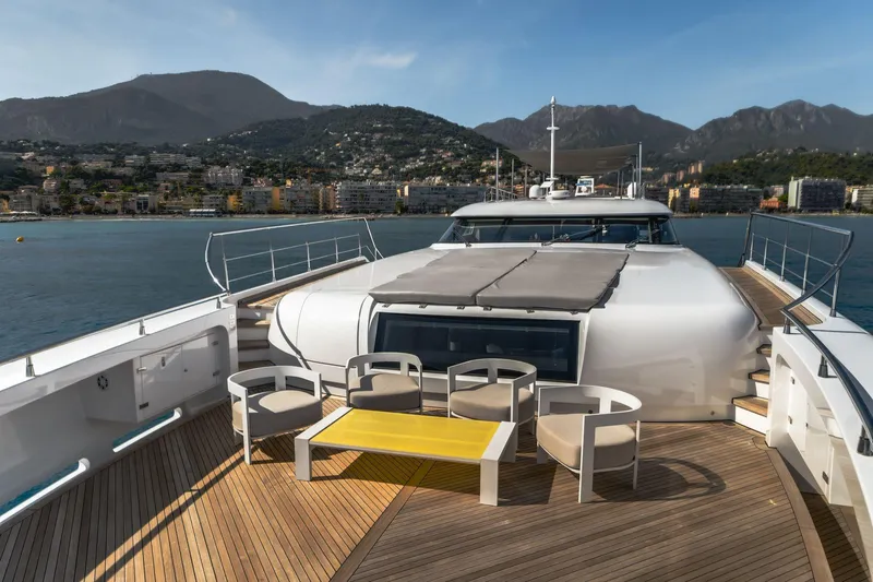 Fast & Furious Yacht Photos Pics Luxurious AB 145 yacht deck with seating, overlooking scenic coastal mountains, 2016 model.