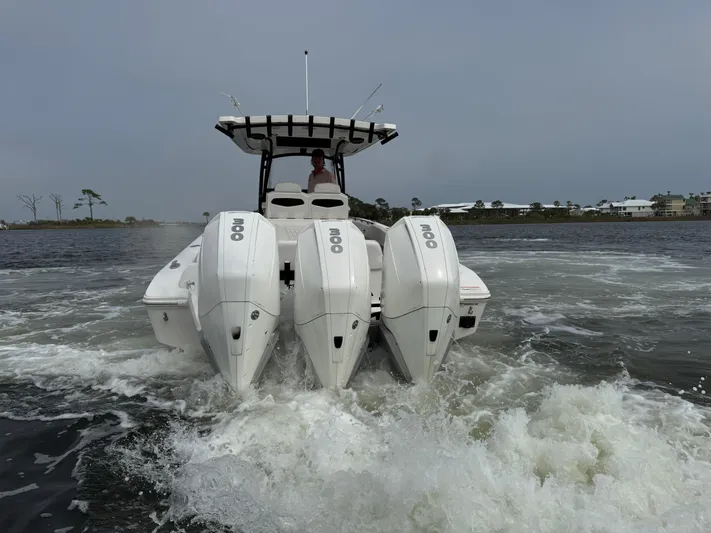  Yacht Photos Pics 2019 Fountain 34 CC boat with triple outboard engines on water.