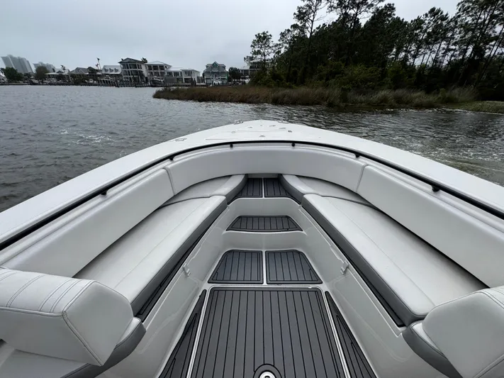  Yacht Photos Pics 2019 Fountain 34 CC boat interior with white seating, on a calm lake.