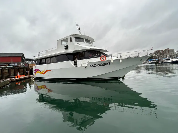 Eloquent Yacht Photos Pics Palmer Marine 70 Pilothouse yacht, 1990 model, docked in a marina on a cloudy day.