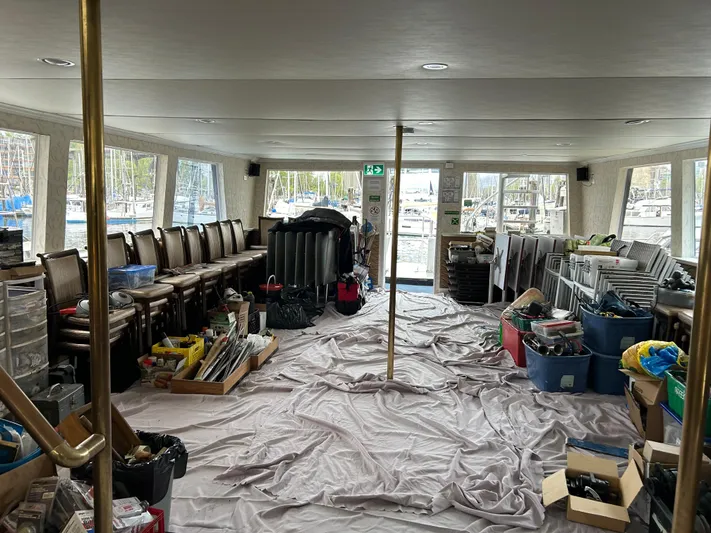 Eloquent Yacht Photos Pics Interior of a 1990 Palmer Marine 70 Pilothouse with chairs and various stored items.