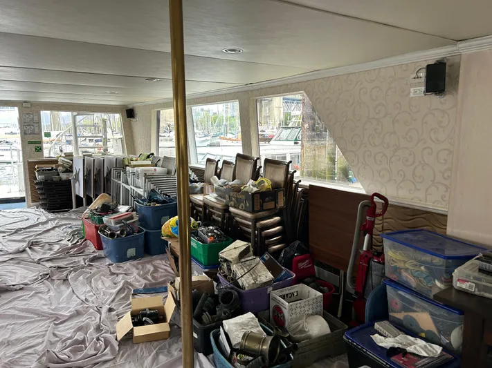 Eloquent Yacht Photos Pics Interior of 1990 Palmer Marine 70 Pilothouse with storage boxes and chairs.