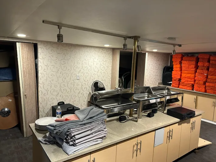 Eloquent Yacht Photos Pics Interior of 1990 Palmer Marine 70 Pilothouse with buffet setup and stacked life jackets.