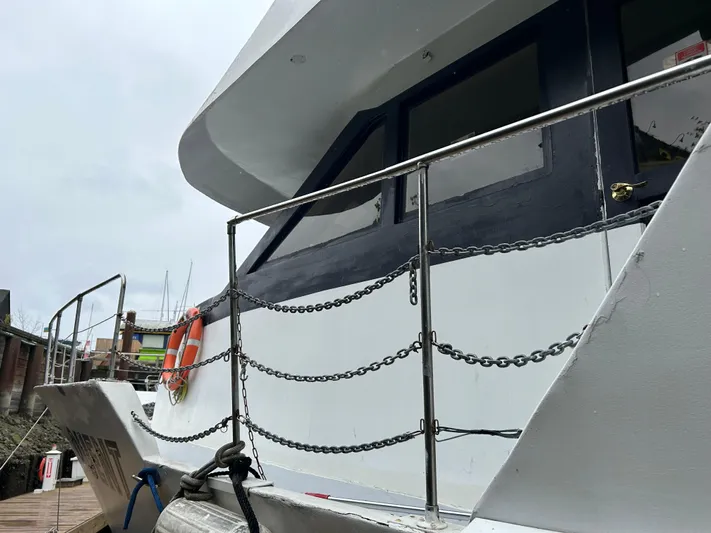 Eloquent Yacht Photos Pics Palmer Marine 70 Pilothouse yacht, 1990 model, docked with visible lifebuoy and railing.