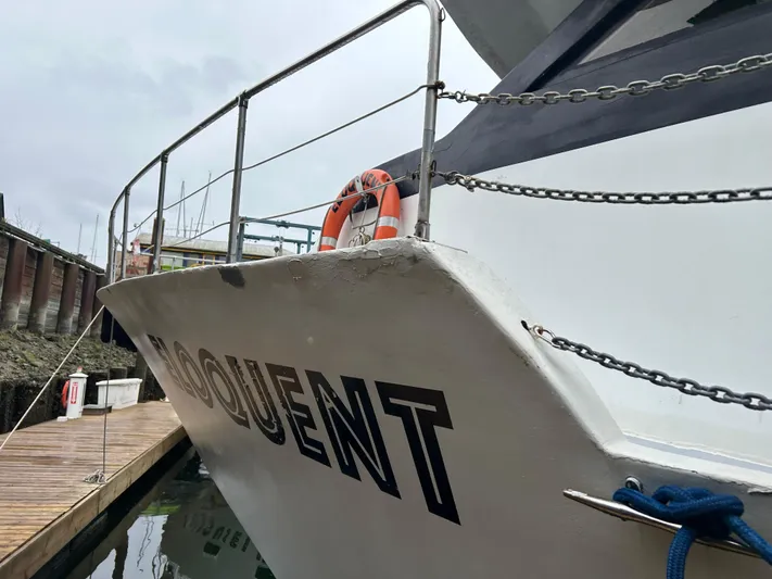Eloquent Yacht Photos Pics Palmer Marine 70 Pilothouse yacht docked, featuring safety railings and lifebuoy, 1990 model.