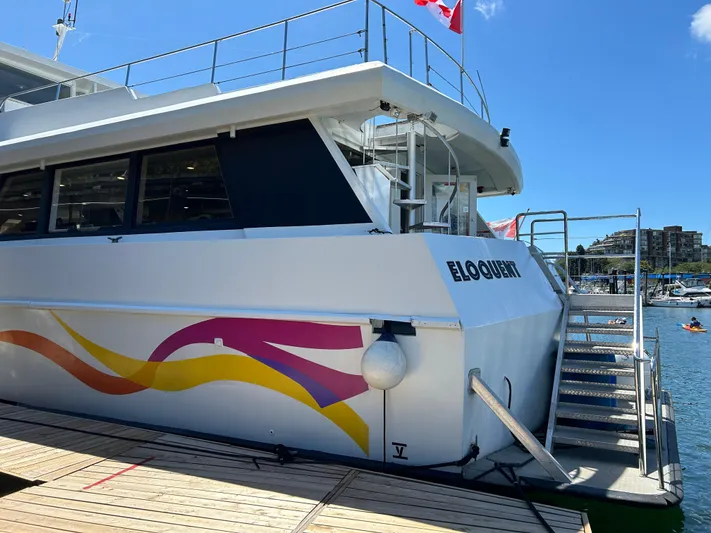 Eloquent Yacht Photos Pics 1990 Palmer Marine 70 Pilothouse docked, featuring colorful design and Canadian flag.
