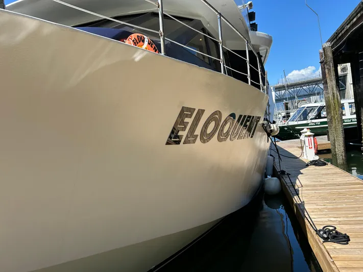 Eloquent Yacht Photos Pics Palmer Marine 70 Pilothouse yacht docked, showcasing sleek design and elegant lettering.