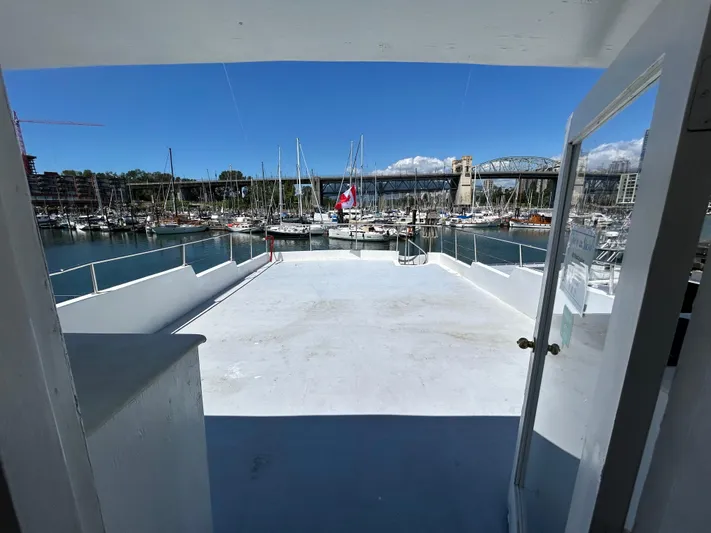 Eloquent Yacht Photos Pics Open deck view from 1990 Palmer Marine 70 Pilothouse, overlooking marina and bridge.