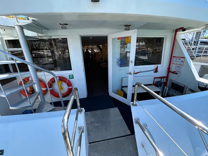 Eloquent Yacht Photos Pics Entrance of 1990 Palmer Marine 70 Pilothouse with open door and safety equipment.