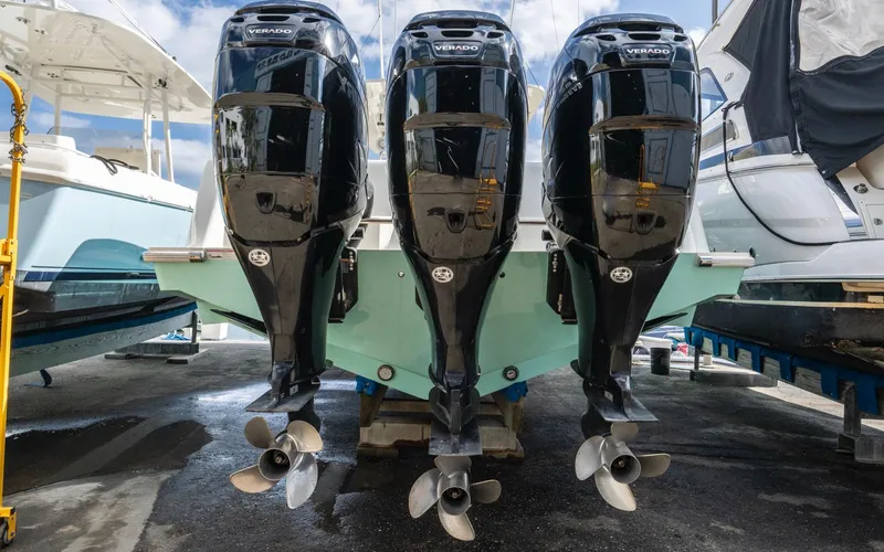 Liquid Asset Yacht Photos Pics 2012 SeaVee 39 LE with triple outboard engines in a marina setting.