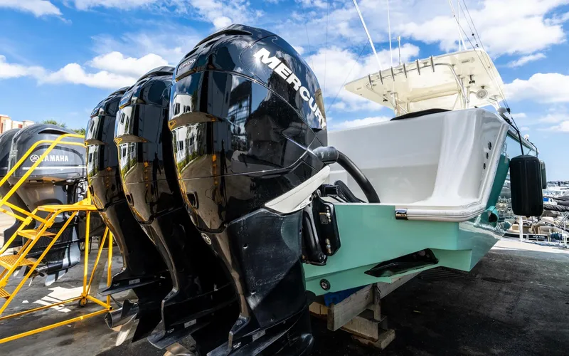 Liquid Asset Yacht Photos Pics 2012 SeaVee 39 LE boat with triple Mercury outboard engines, docked under a blue sky.