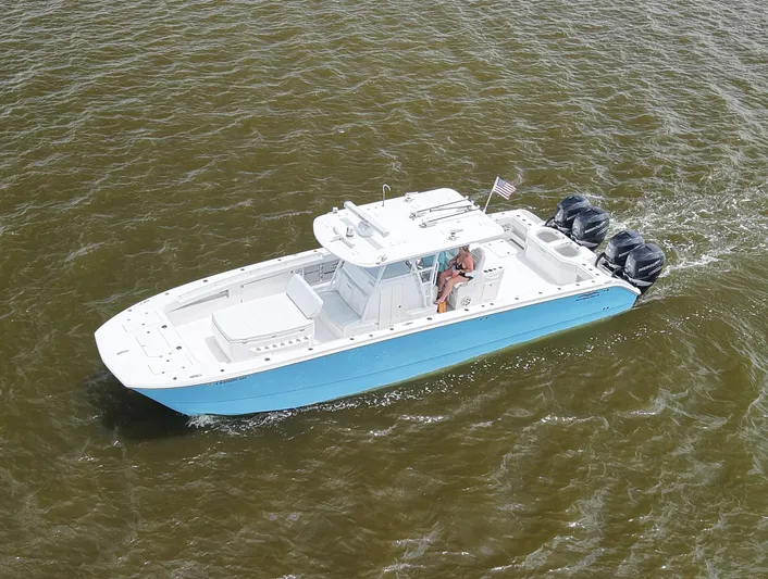  Yacht Photos Pics 2018 Invincible 40 Catamaran cruising on water, featuring triple outboard engines.