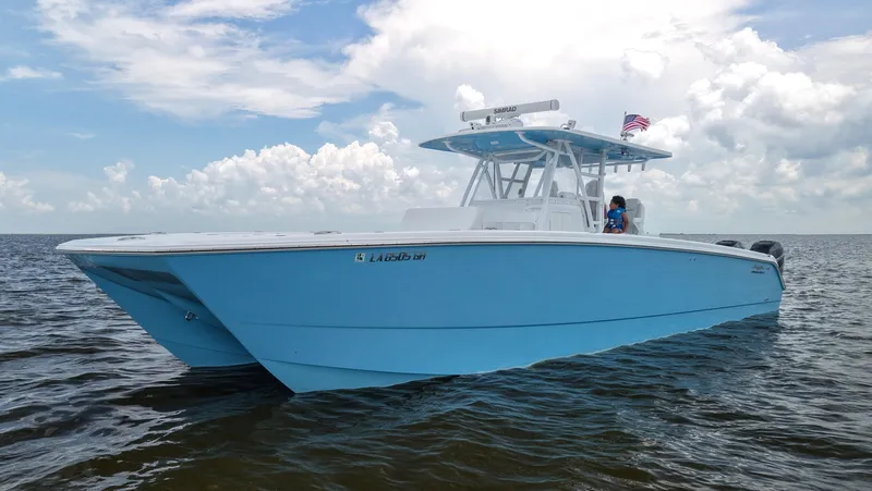  Yacht Photos Pics 2018 Invincible 40 Catamaran in blue on open water under cloudy sky.