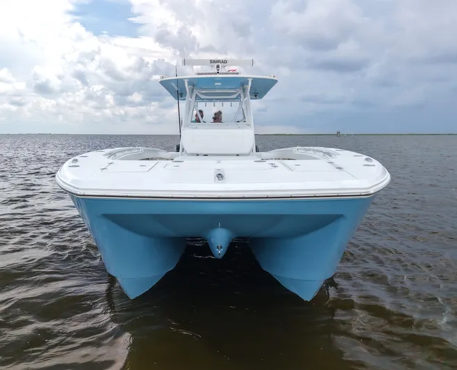  Yacht Photos Pics 2018 Invincible 40 Catamaran on water, showcasing sleek design and blue hull.