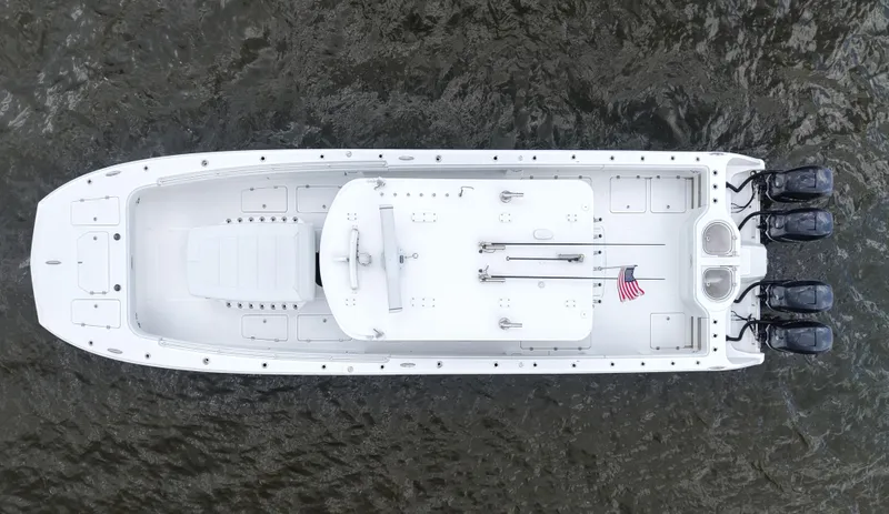  Yacht Photos Pics Overhead view of 2018 Invincible 40 Catamaran on water, featuring sleek design and multiple engines.