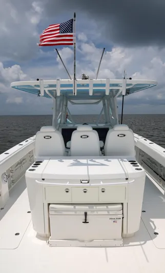  Yacht Photos Pics Invincible 40 Catamaran 2018 with American flag, ocean backdrop, and cloudy sky.