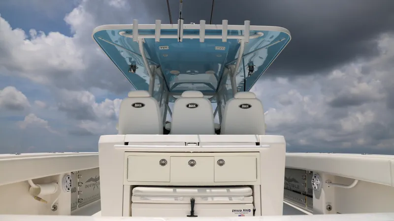  Yacht Photos Pics 2018 Invincible 40 Catamaran interior with seating and storage under cloudy sky.