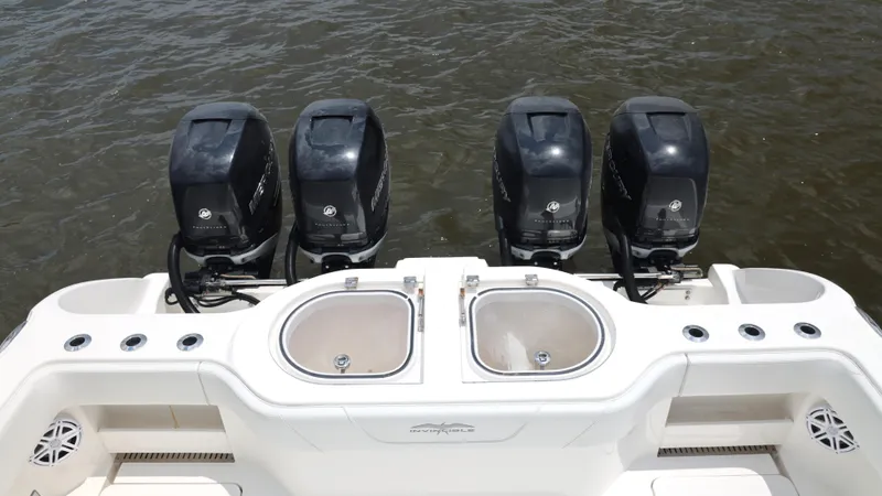  Yacht Photos Pics Four powerful outboard engines on a 2018 Invincible 40 Catamaran, docked on water.