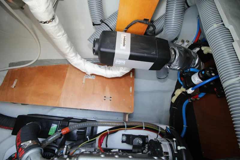 Vela Yacht Photos Pics Engine compartment of a 2021 Lagoon 46 catamaran, showcasing mechanical components and wiring.
