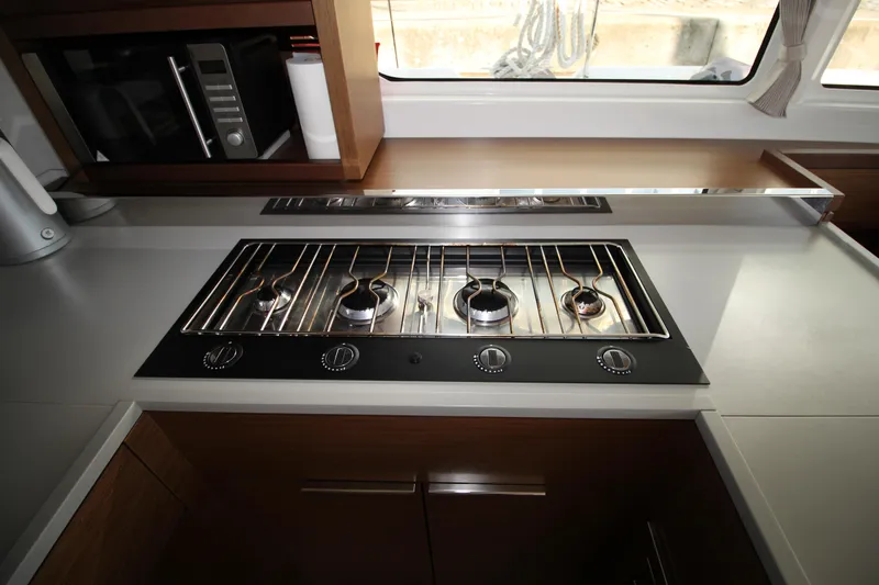 Vela Yacht Photos Pics Modern kitchen stove in 2021 Lagoon 46 yacht, featuring sleek design and stainless steel finish.