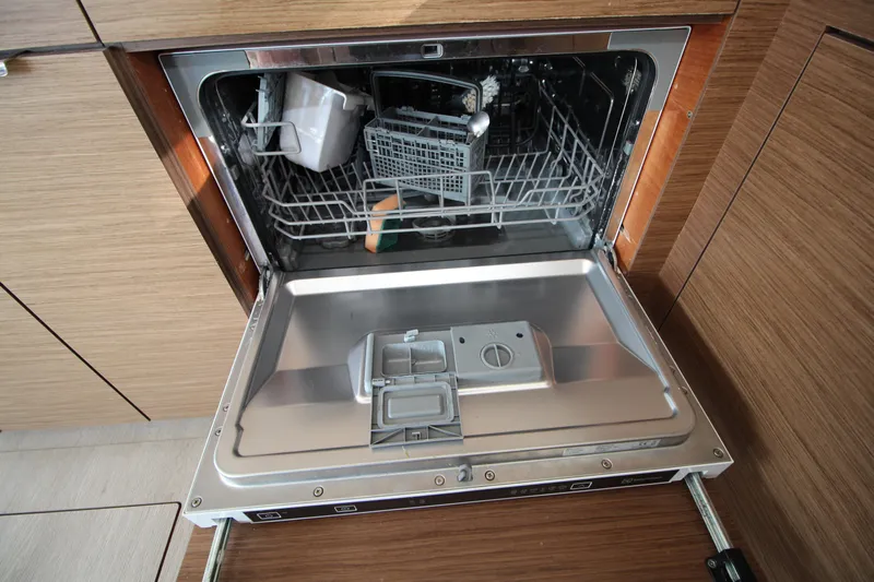 Vela Yacht Photos Pics Open dishwasher in a 2021 Lagoon 46 yacht kitchen.