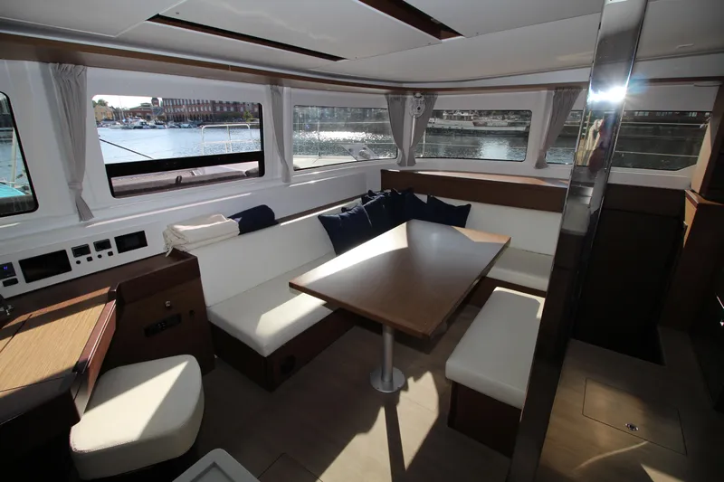 Vela Yacht Photos Pics Interior of 2021 Lagoon 46 yacht with spacious seating and dining area.