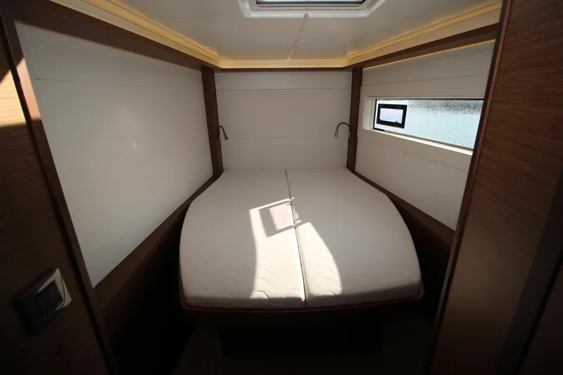 Vela Yacht Photos Pics Luxurious cabin interior of 2021 Lagoon 46 catamaran with cozy double bed.