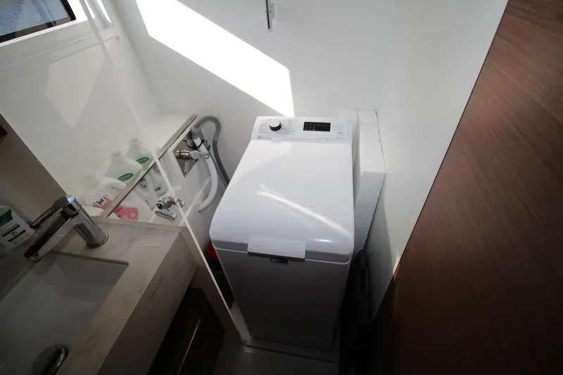 Vela Yacht Photos Pics Laundry area with washing machine in 2021 Lagoon 46 yacht bathroom.
