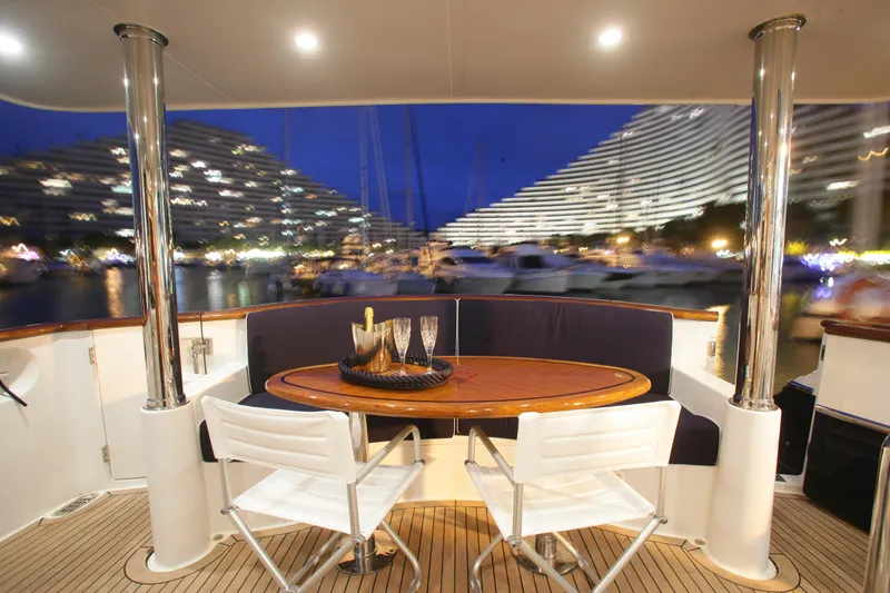  Yacht Photos Pics Luxurious Selene 62 yacht deck with elegant seating, overlooking marina at night, 2026 model.