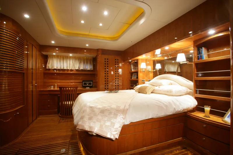  Yacht Photos Pics Luxurious Selene 62 yacht bedroom interior, 2026 model, featuring elegant wood finishes and ambient lighting.