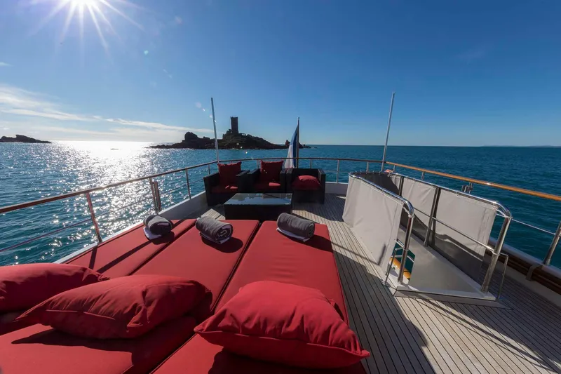  Yacht Photos Pics Luxurious Selene 62 yacht deck with red loungers, ocean view, and sunny sky, 2026 model.