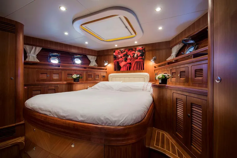  Yacht Photos Pics Luxurious Selene 62 yacht bedroom, 2026 model, featuring elegant wood paneling and cozy bedding.