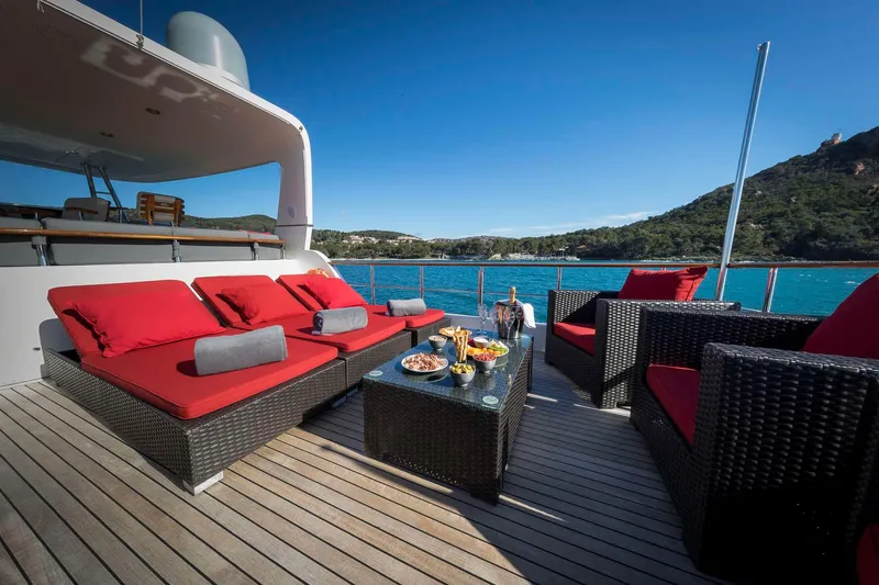  Yacht Photos Pics Luxurious Selene 62 yacht deck with red seating, ocean view, and refreshments, 2026 model.