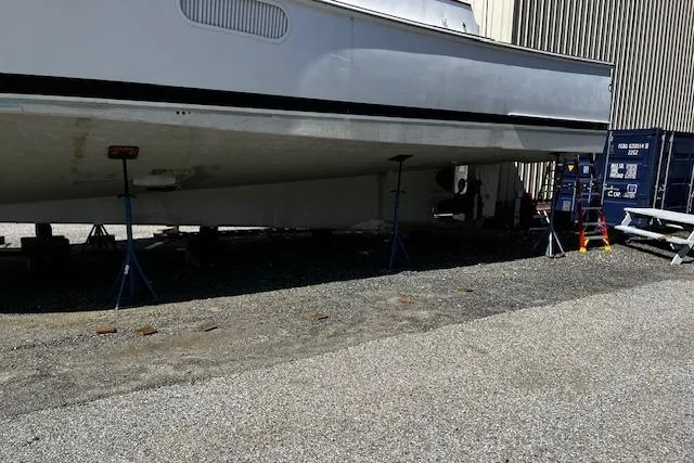 Moses Yacht Photos Pics 2003 Lyman-Morse Wesmac Sportfish Cruiser on stands, side view, outdoor storage.