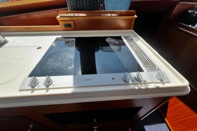 Moses Yacht Photos Pics 2003 Lyman-Morse Wesmac Sportfish Cruiser kitchen with modern stovetop and wooden cabinetry.