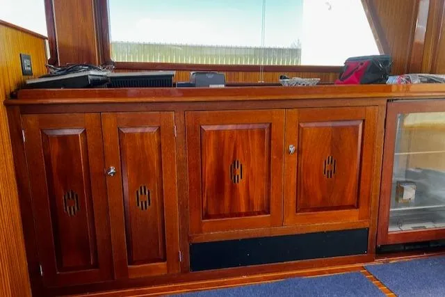 Moses Yacht Photos Pics Wooden cabinetry inside 2003 Lyman-Morse Wesmac Sportfish Cruiser, featuring elegant design and storage.
