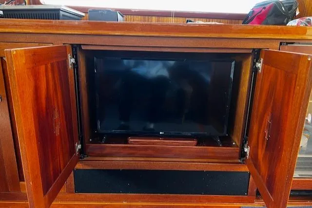 Moses Yacht Photos Pics 2003 Lyman-Morse Wesmac Sportfish Cruiser interior with wooden cabinet and built-in TV.