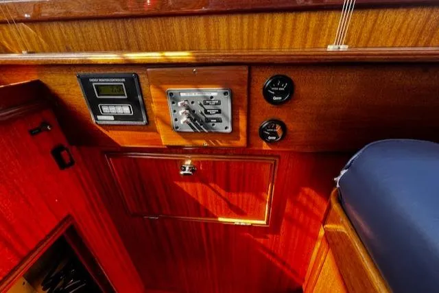 Moses Yacht Photos Pics Control panel of 2003 Lyman-Morse Wesmac Sportfish Cruiser with wood finish and gauges.