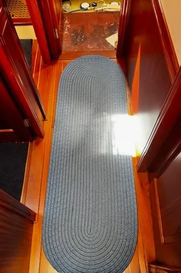 Moses Yacht Photos Pics Blue oval rug on polished wooden floor of 2003 Lyman-Morse Wesmac Sportfish Cruiser.