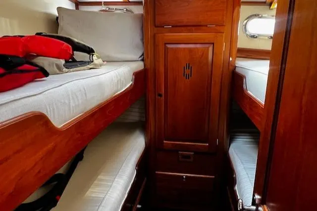 Moses Yacht Photos Pics 2003 Lyman-Morse Wesmac Sportfish Cruiser cabin with wooden interior and bunk beds.