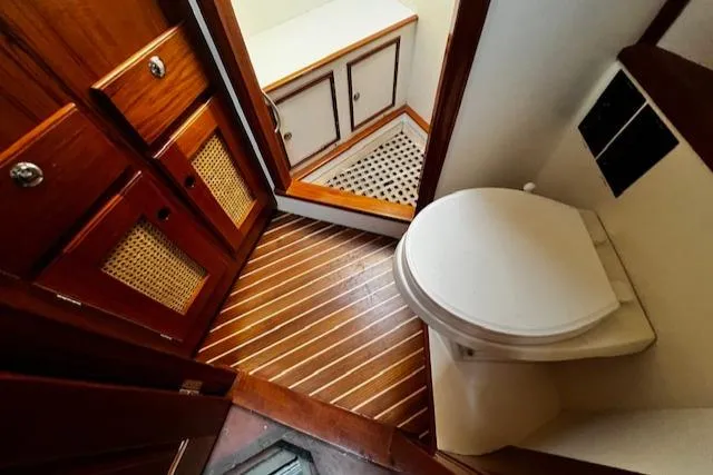 Moses Yacht Photos Pics 2003 Lyman-Morse Wesmac Sportfish Cruiser bathroom with wooden cabinetry and flooring.