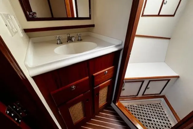 Moses Yacht Photos Pics 2003 Lyman-Morse Wesmac Sportfish Cruiser bathroom with wooden cabinetry and white sink.
